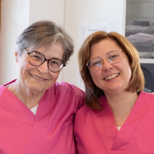 Smiling woman with hands on heart.