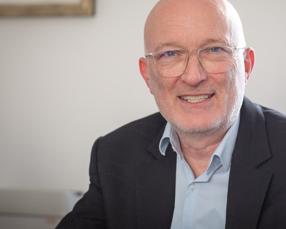 Portrait of Frank smiling.